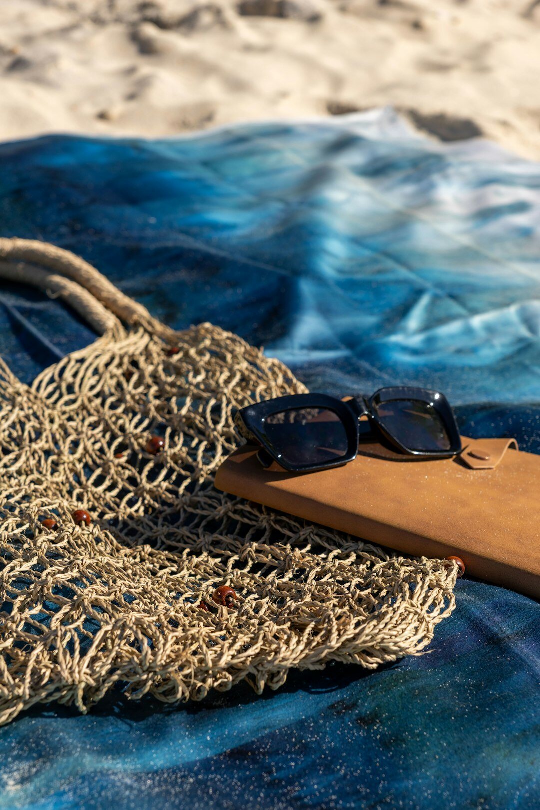 Polarized luxury sunglasses on a sunlit beach towel